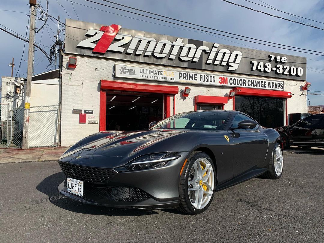 A black Ferrari in front of 212 Motoring