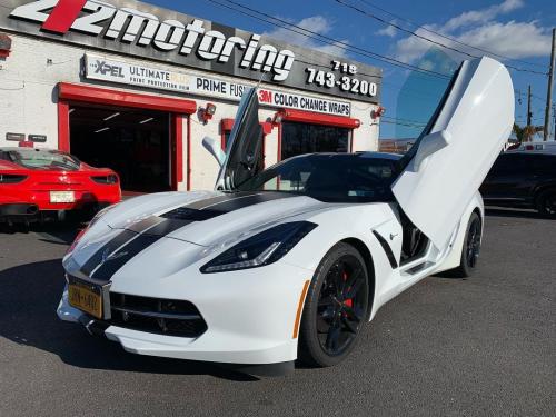 White Corvette with scissor doors in front of 212 Motoring