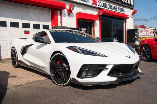 A white Corvette outside of 212 Motoring